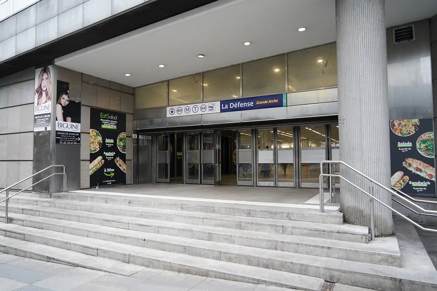 Entrance to La Défense Grande Arche station, with RER, metro, tram and bus pictograms above the doors.