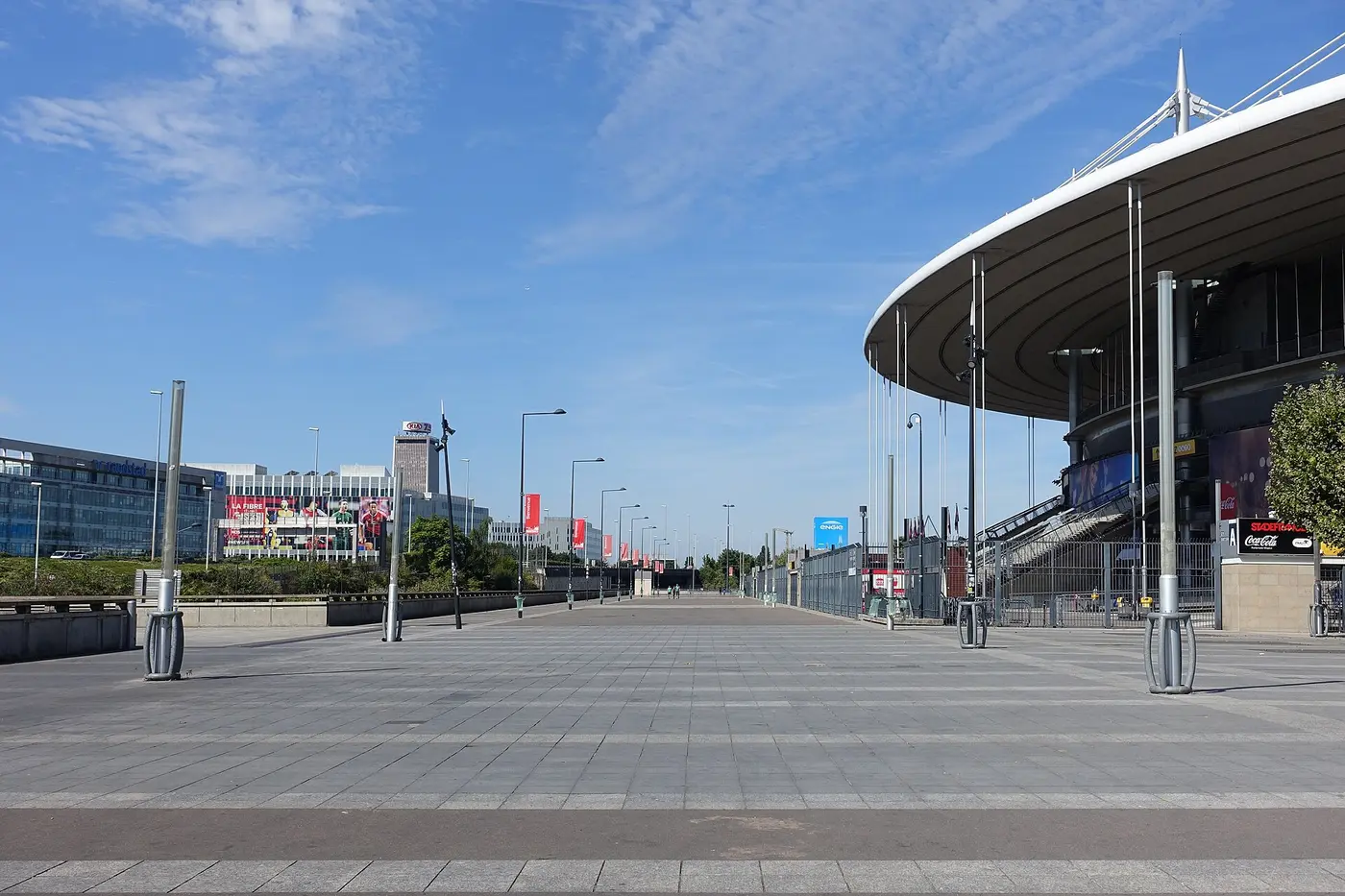 Esplanade of Stade de France in Saint-Denis, exterior view with the stadium's distinctive roof structure.